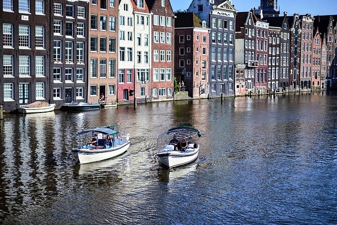 Amsterdam 2-hour Private Canal Cruise with Live Guide and Drinks - ARTIS Royal Zoo From the Water: Nature, Urban Sounds, and a Break in the City Grid