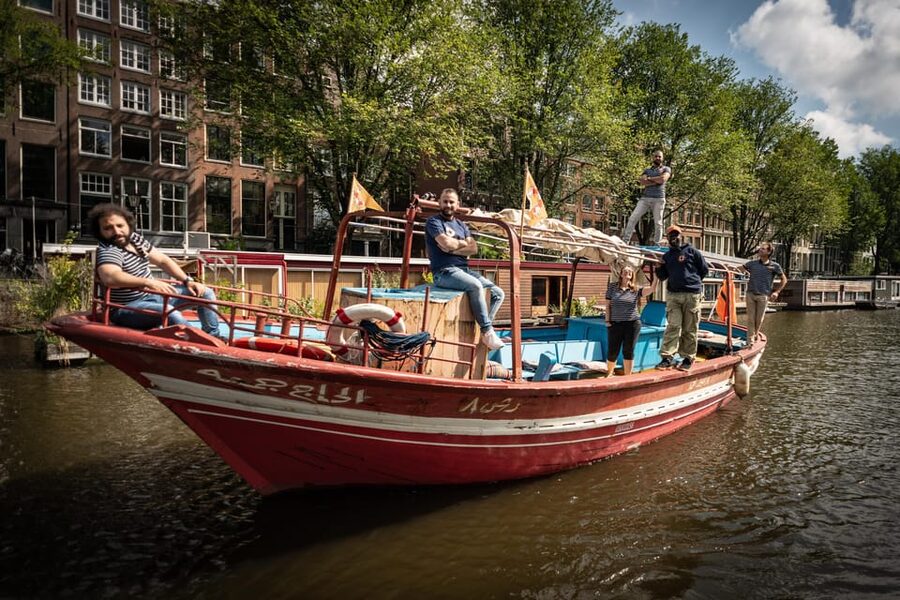 Amsterdam: Canal Cruise on a Wooden Refugee Boat - The 90-minute cruise: canals, the Amstel, and what you notice along the way