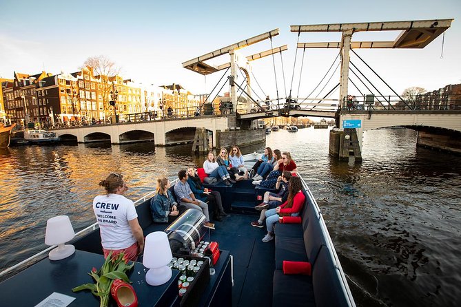 Amsterdam Canal Cruise With Live Guide and Unlimited Drinks - Open-Air Summer Views vs Winter Heated Comfort