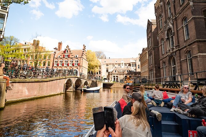 Amsterdam Canal Cruise with Live Guide - Central Station - Weather-proof comfort: open boats in summer, heated seats in winter