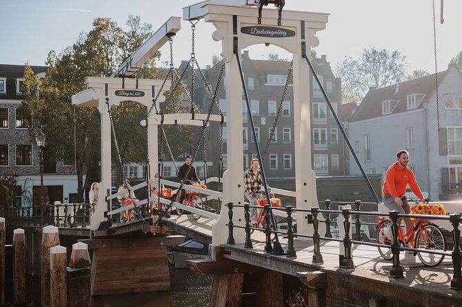 Amsterdam City Top Highlights Guided Bike Tour - Leidseplein to Dam Square: squares, nightlife energy, and iconic landmarks