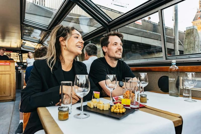 Amsterdam: Cozy Cheese & Wine Cruise Tasting Experience - The cheese platter, nuts, and the unlimited drinks setup that drives the whole experience