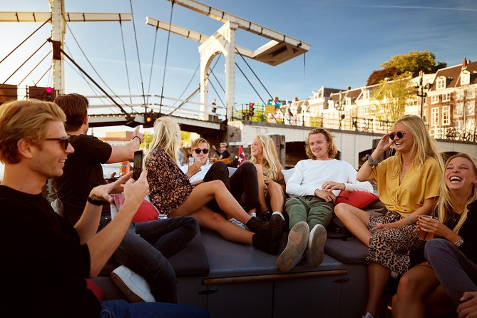 Amsterdam Light Festival: Saloon Boat Cruise + Hot Drinks & Bite - Covered saloon boat reality: viewing windows, cold air, and seating issues