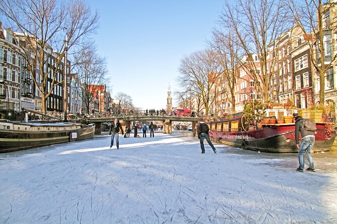 Amsterdam Light Festival Winter Walk with Stroopwafel Workshop - Meeting at Dam Square: finding your orange-umbrella guide