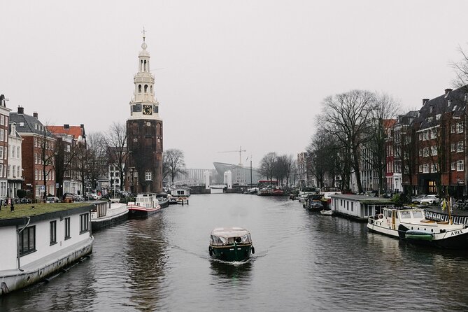 Amsterdam Newest Canal Cruise with local guide and small group - The boat and weather setup: open views, ponchos, and cozy layers