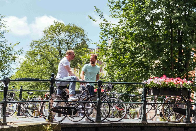 Amsterdam PRIVATE Bike Tour With Locals: Bike & Local Snack Included - Stop 2: Magere Brug (Skinny Bridge), the photo moment that feels like a mini show