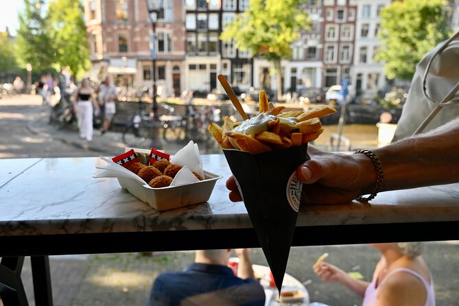 Amsterdam Private Food & Drinks Tour by UNESCO Canals & Jordaan - Bloemenmarkt and Spui: flowers, a church university, and the feeling of old Amsterdam