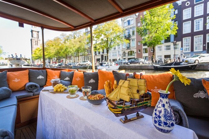 Amsterdam Small-Group Bike Tour With Canal Cruise, Drinks, Cheese - Prins Hendrik Bust and the transition to your canal cruise