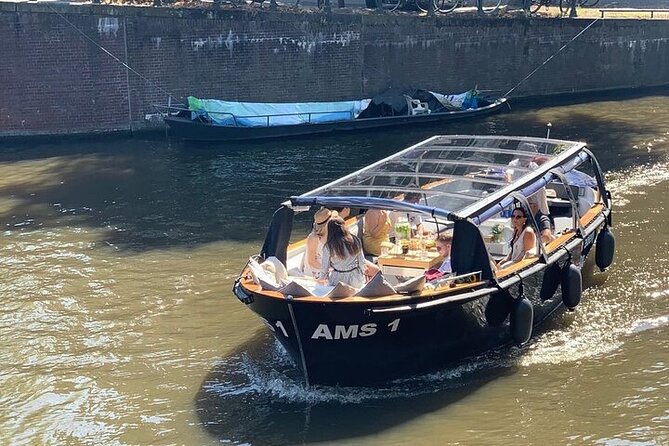 Amsterdam Small-Group Canal Cruise Including Snacks and Drinks - The canal route: Jordaan views and landmark spotting without the crowd squeeze