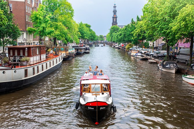 Amsterdam Small-Group Canal Cruise With Dutch Snacks and Drink - Flea Market Energy, Old Amsterdam Corners, and an LGBT Monument Stop