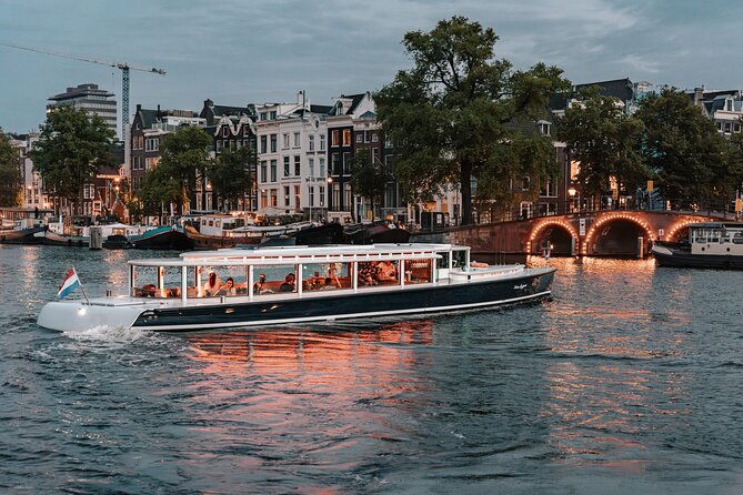 Amsterdam Small-Group Evening Canal Cruise Including Wine, Craft Beer, Cheese - Amsterdam at night, from the water, for about 90 minutes