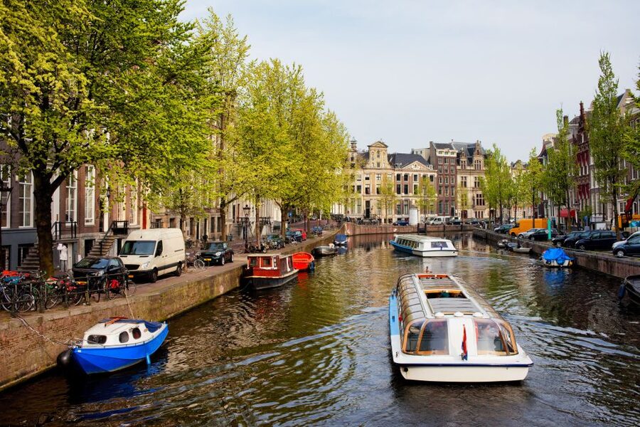 Amsterdam Walking Tour and Canal Cruise - Dam Square, royal sights, and the war monument context
