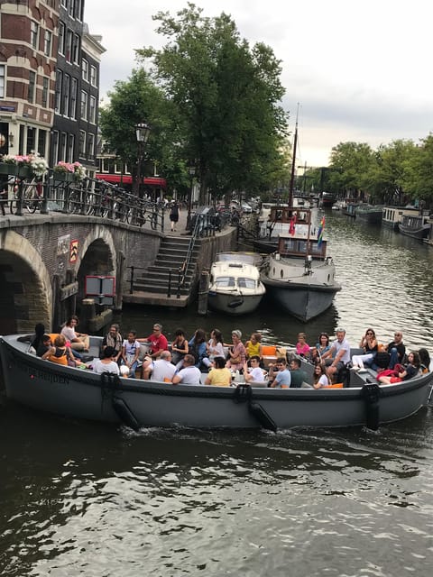 Visit Amsterdam by Boat with a French Guide (french) - Small electric boat comfort and the bonus of quieter canals